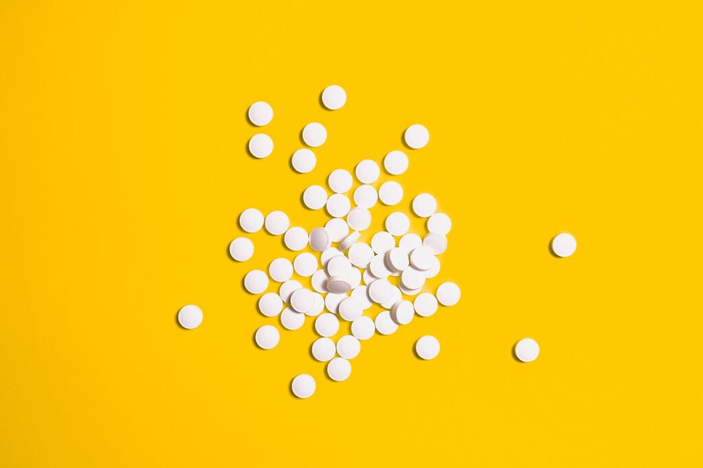 yellow background and white round pills