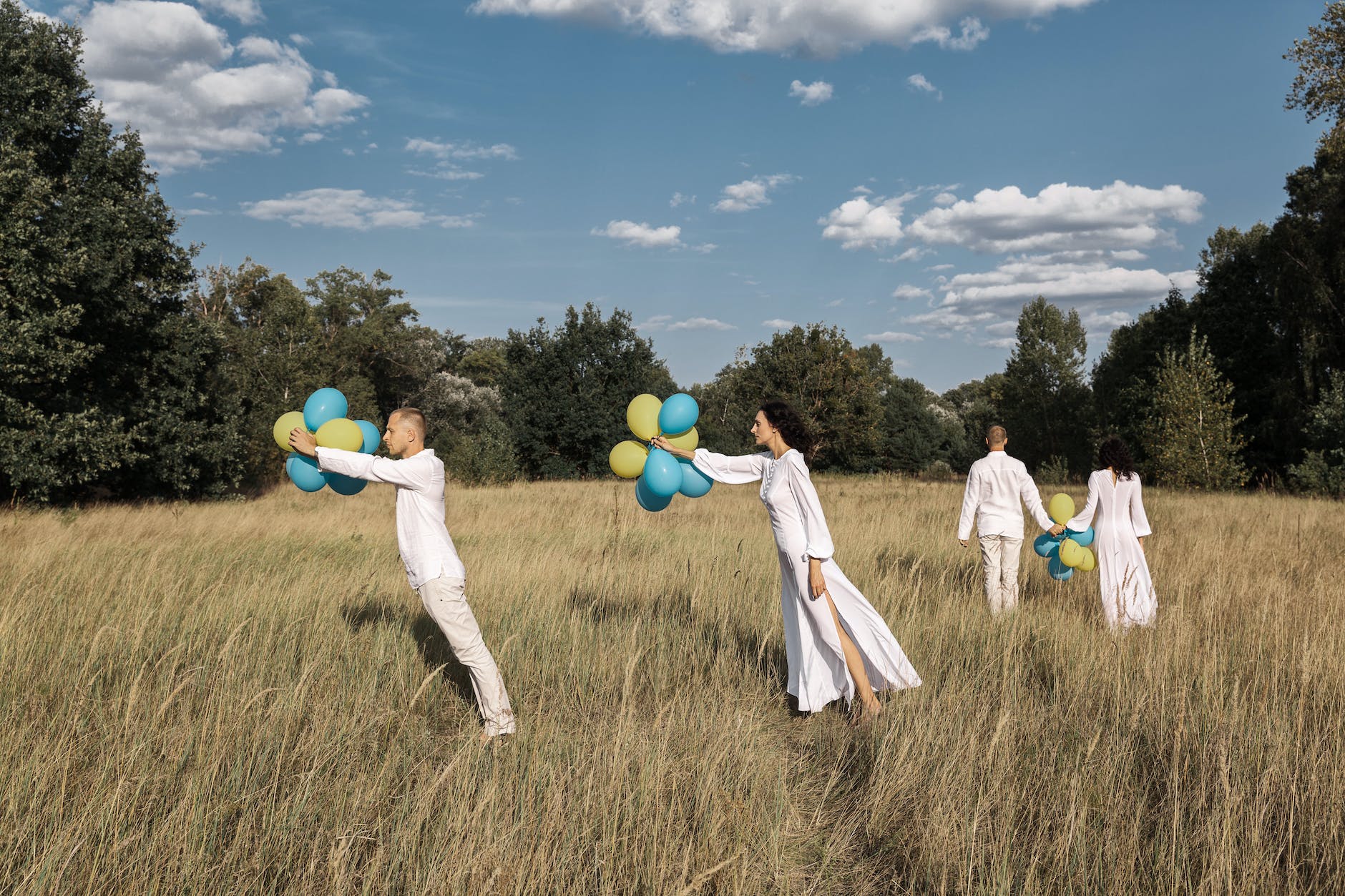 people holding balloons on a field