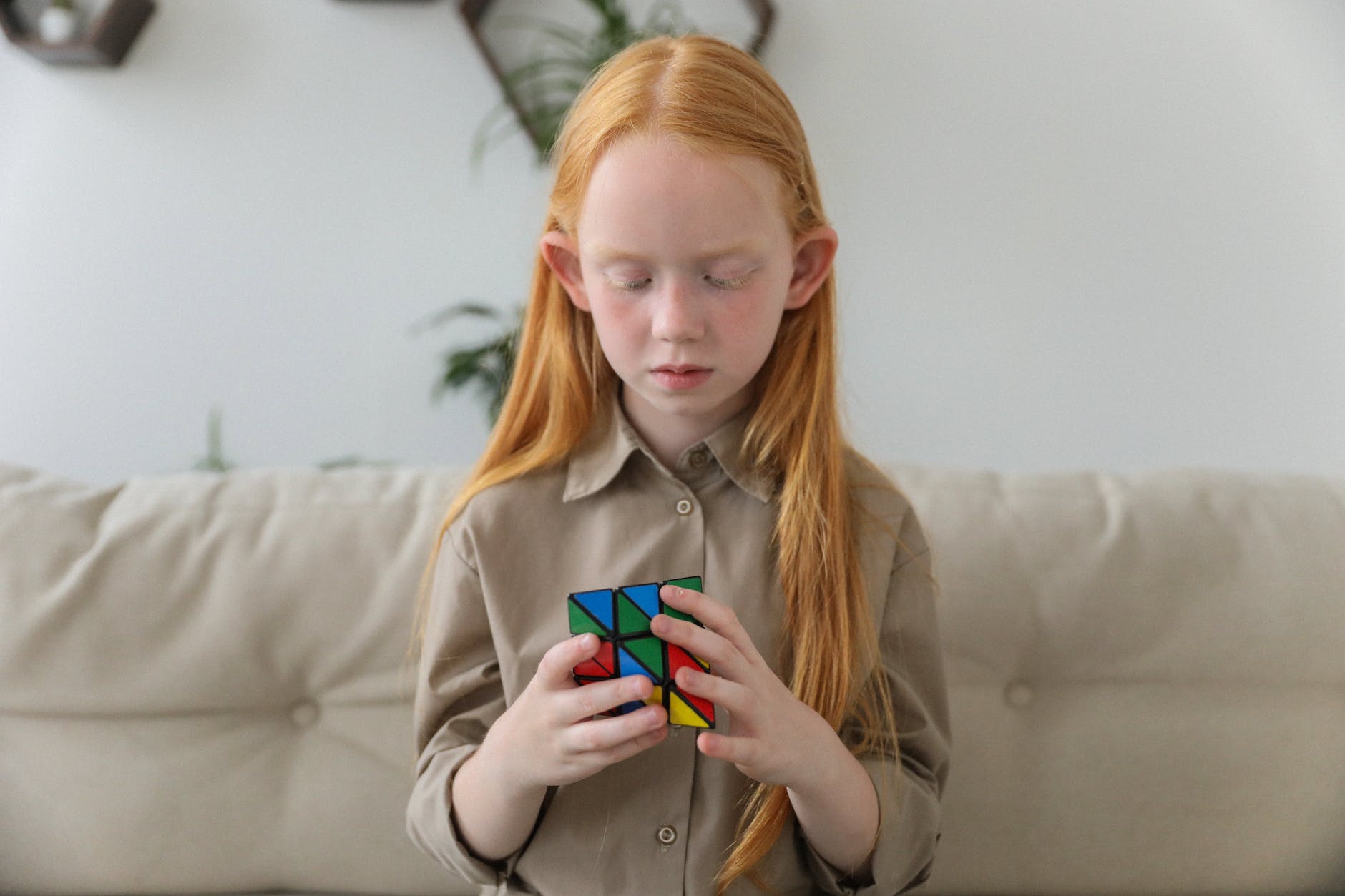 cute girl thinking over bright puzzle cube