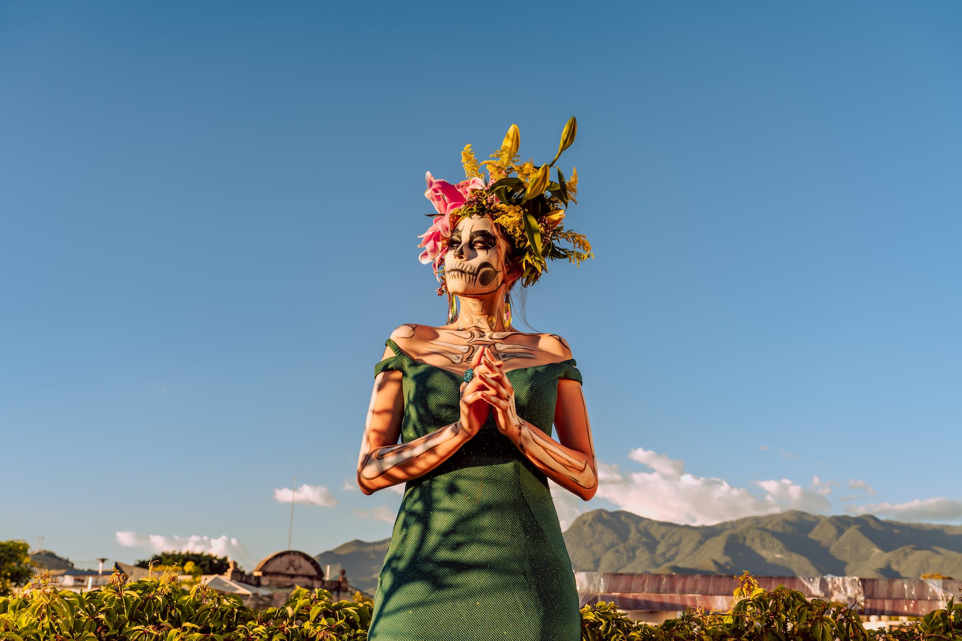portrait of woman wearing traditional dia de los muertos makeup